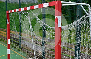 Multifunctional outdoor playground for ball games at school. green artificial turf from a plastic carpet with lines. basketball ho