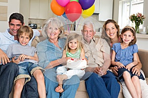 Multigeneration family celebrating girls birthday