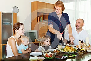 Multigeneration family communicate over table