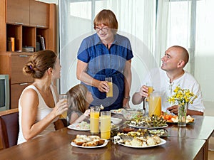 Multigeneration family communicate over table