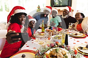 Multigeneration family having christmas dinner together