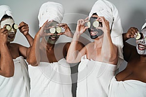 Multigenerational women having fun wearing face beauty mask with cucumbers on their eyes - Skin care therapy - Main focus on