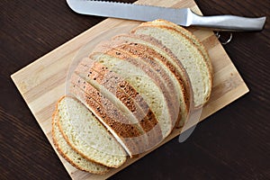 Multigrain bread with a knife on the chopping board.