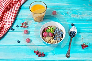 Multigrain wholewheat healthy cereals with fresh berry and a glass of juice for breakfast