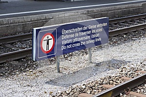 Multilingual warning sign at the railroad station platform