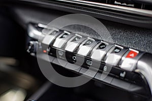 multimedia control console and climate in a modern car. close-up, selective focus, no people