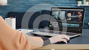 Multimedia designer using software to edit video footage
