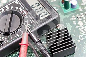 Multimeter on PCB plate.