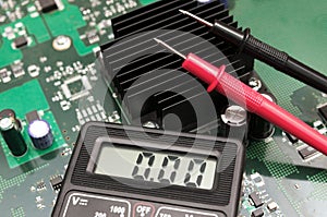 Multimeter on PCB plate.