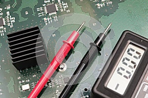 Multimeter on PCB plate.