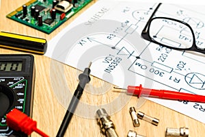 Multimeter probes examining a computer circuit board and circuit