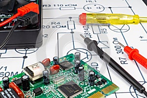 Multimeter probes examining a computer circuit board