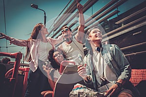 Multinational friends on a sightseeing bus