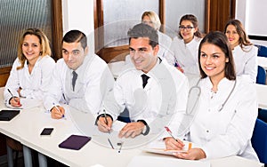 Multinational interns and professor having discussion