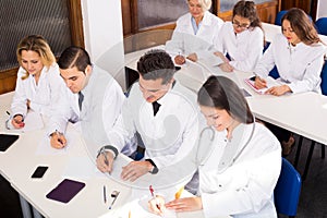 Multinational interns and professor having discussion