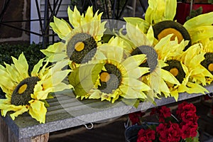 Multiple artificial outdoor yellow sunflowers