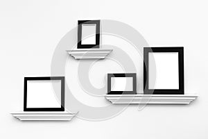 Multiple Blank picture frames on Ledges on a wall