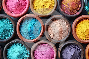 Multiple bowls filled with vibrant colored powders, arranged for the Holi Festival of Colors celebration