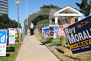 Multiple campaign signs with voters