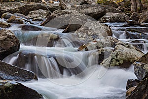 Multiple cascades of water across lichen covered rocks in the Great Smoky Mountains