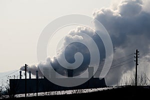 Multiple coal fossil fuel power plant smokestacks emit carbon dioxide pollution.