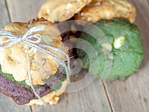 Multiple color cookies inclusive peanut butter, green tea cookies, and Chocolate Chip Cookies. Overlaid by alternating colors on w