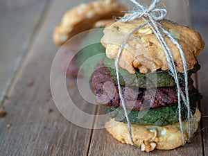 Multiple color cookies inclusive peanut butter, green tea cookies, and Chocolate Chip Cookies. Overlaid by alternating colors on w