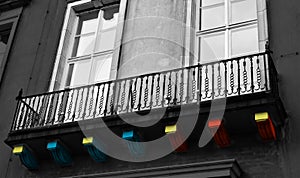 Multiple colours painted on woods under a metallic protection wall of a house balcony