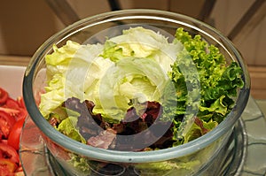 Multiple cut vegetable salad on a glass bowl