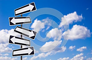 Multiple directions signs on blue sky photo