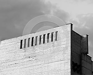 Multiple embrasure windows on brick buildings background