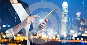 Multiple exposure of female programmer with tablet, digital binary code and night city.