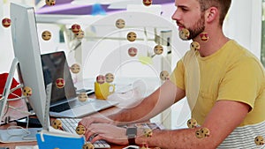 Multiple face emojis floating against man using computer at office