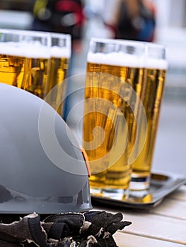 Multiple glasses of beer on a table with climbing equipment gloves helmet Zugspitze, Germany