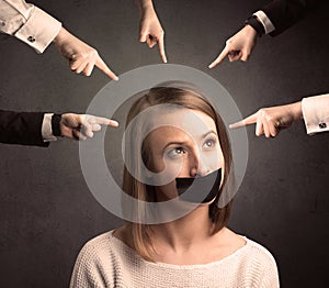 Multiple hands pointing at woman