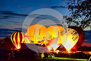 Multiple Hot Air Balloon Glow as Balloons Fire There Propane Tanks and Light Up the Balloons