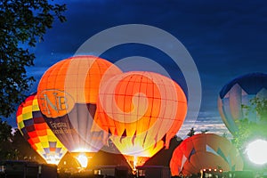 Multiple Hot Air Balloon Glow as Balloons Fire There Propane Tanks and Light Up the Balloons