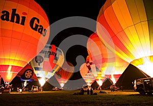 Multiple hot air balloons night glow