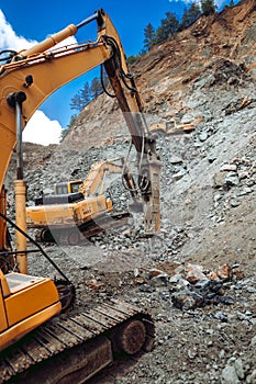 Multiple machineries working on construction site. Details of excavators working on site