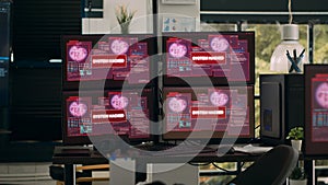 Multiple monitors with critical error message flashing on screens with hacking alert