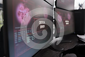 Multiple monitors showing critical error message after cyber crime attack