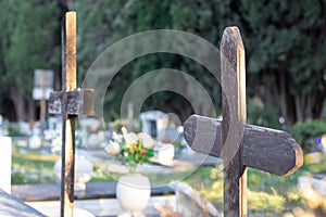 Multiple old brown wooden ruined crosses marking unknown grave