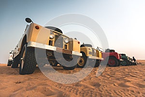 Multiple old Land Rover in the desert of Dubai - UAE