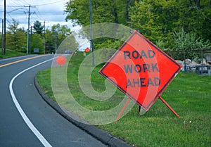 Multiple orange Road Work Ahead signs