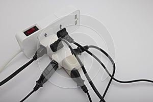 Multiple power socket with connected plugs , Multi plug electrical power strip on a white background , Unsafety concept