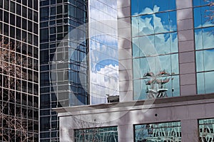 Multiple reflections sky clouds towers building in glass panels Regina Canada