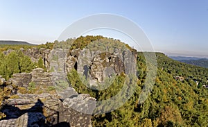 Multiple rock formations surrounded by dense growth of greenery