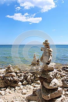 Multiple rock totems along the rocky shoreline of Lake Michigan in Sturgeon Bay, Wisconsin