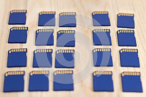 Multiple SDHC memory cards on wooden surface - shallow focus