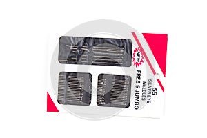 Multiple sized silver sewing needles in a pack isolated over white